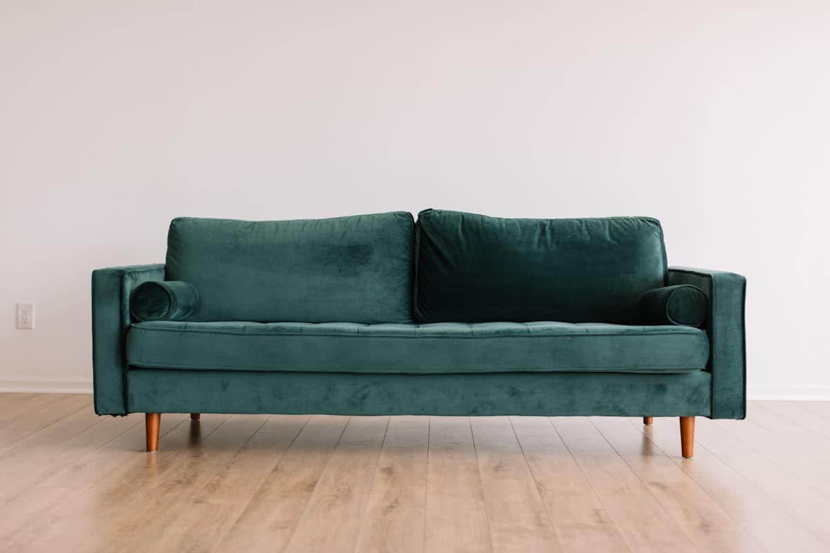 An empty couch in a dimly lit room, waiting